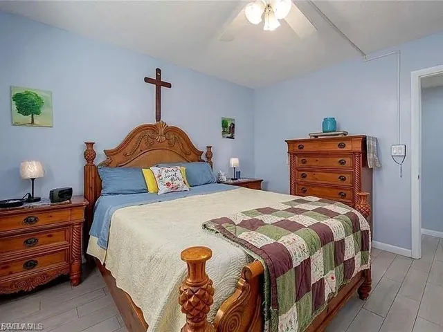 Bedroom featuring a ceiling fan and light wood-type flooring