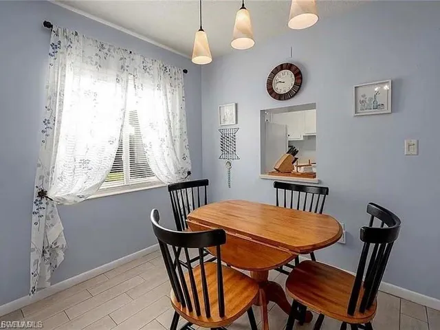 Dining area with baseboards and wood finish floors