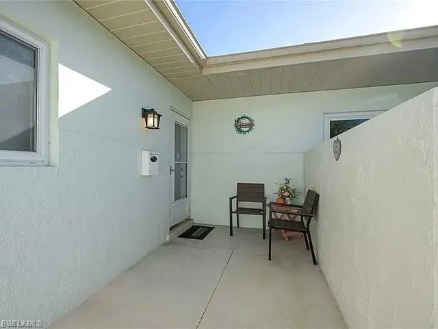 Entrance to property featuring a patio area and stucco siding