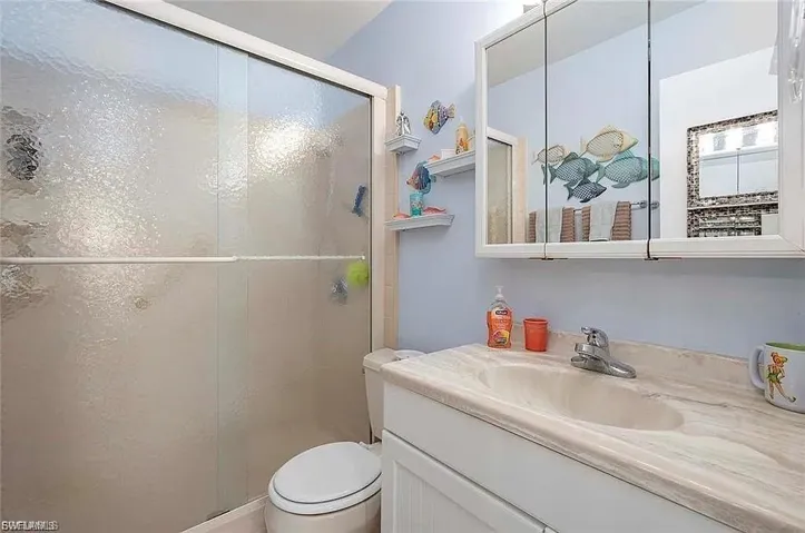 Bathroom with vanity and a stall shower