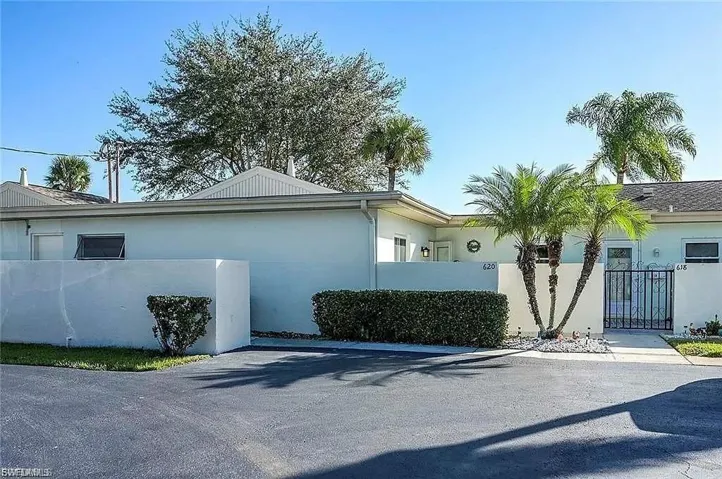 View of home's exterior with a fenced front yard, a gate, and stucco siding