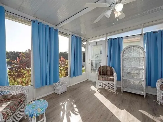 Sunroom / solarium with a ceiling fan