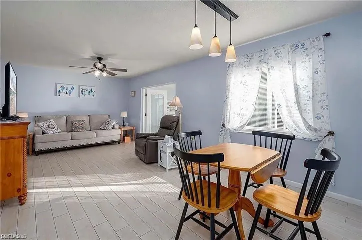 Dining area with wood finish floors and ceiling fan