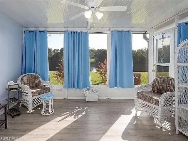 Sunroom / solarium featuring wood finished floors and wooden ceiling