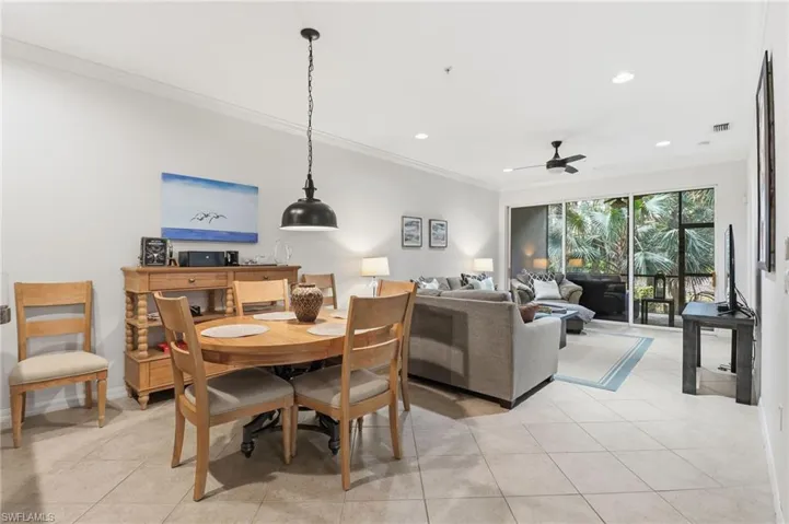 Dining area with crown molding, light tile patterned flooring, ceiling fan, and recessed lighting