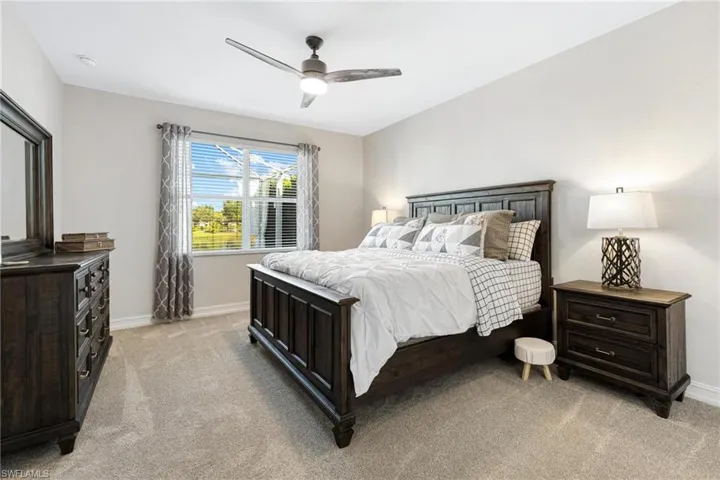 Bedroom featuring light carpet and ceiling fan