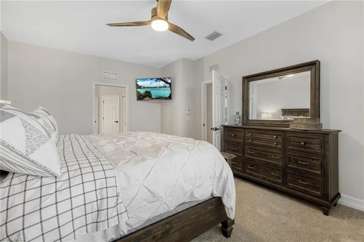 Bedroom featuring light carpet and ceiling fan