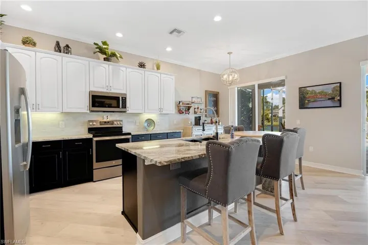 Kitchen with tasteful backsplash, and stainless steel appliances