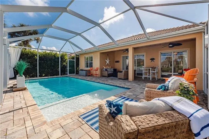 View of pool with a patio, a lanai, outdoor lounge area