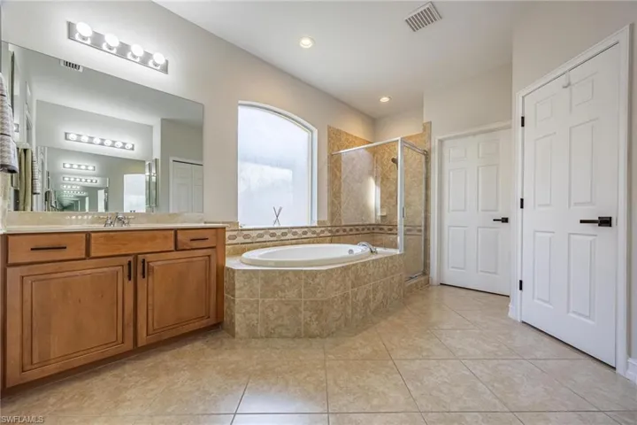 Owners bathroom with walk in shower and soaking tub
