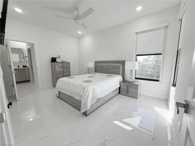 Bedroom with ceiling fan and ensuite bath