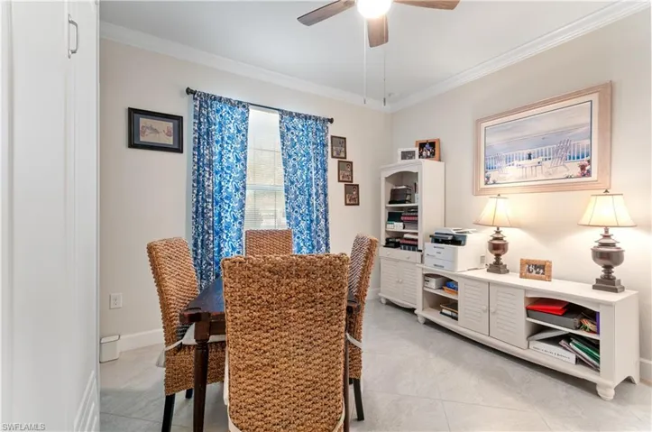Bedroom featuring crown molding, ceiling fan, and light tile patterned floors