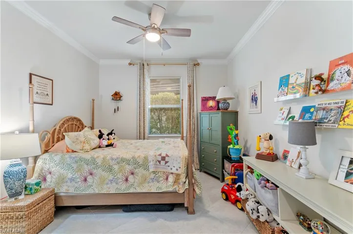 Bedroom featuring crown molding, a ceiling fan, and light tile patterned flooring