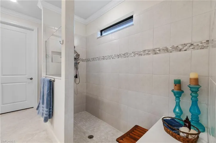 Full bathroom featuring a walk in shower and ornamental molding