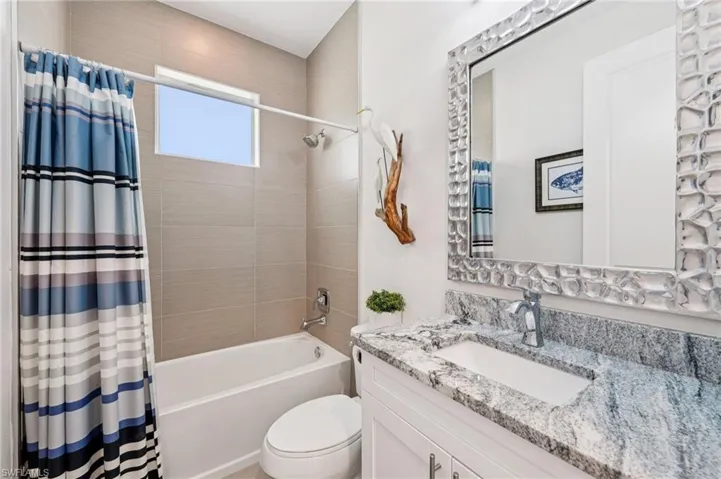 Bathroom with shower / tub combo and vanity