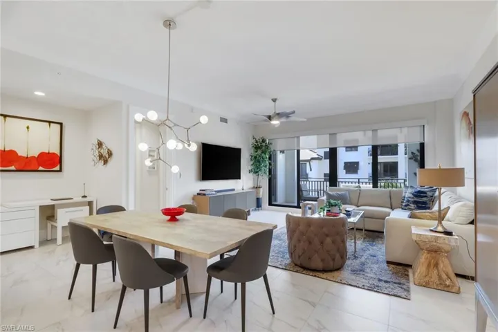 Dining space with a chandelier and a ceiling fan