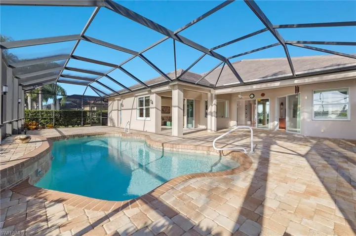 View of swimming pool with a patio and a lanai