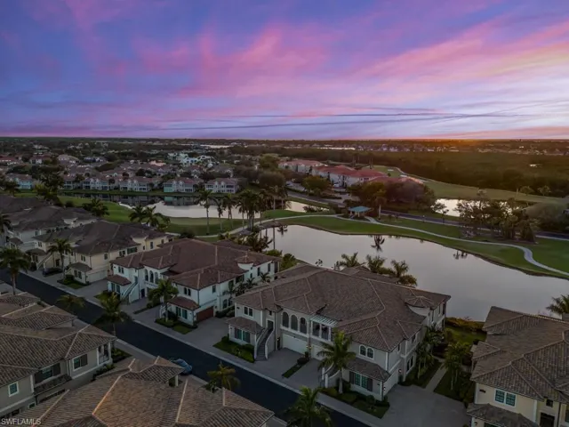 Aerial view at dusk featuring a water & golf course view