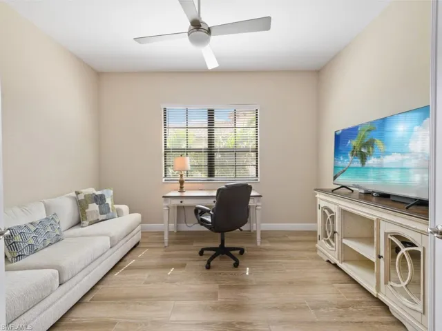 Home office with ceiling fan and light wood-type flooring