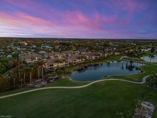 Aerial view at dusk featuring a spectacular water and golf course view