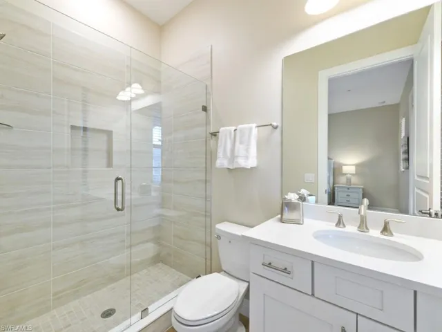 Guest Bathroom with vanity, toilet, and an enclosed shower
