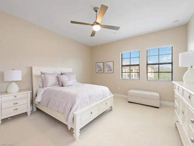 Ensuite Guest Bedroom featuring luxury carpet and ceiling fan