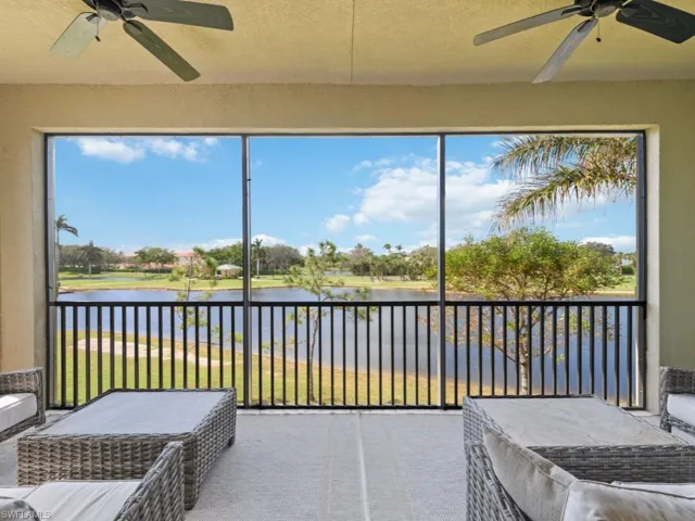 Screened lanai featuring ceiling fan and a water and golf course view