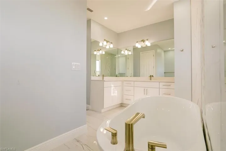Bathroom with double vanity and a freestanding bath