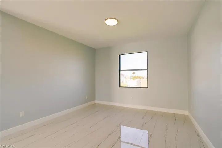 Unfurnished room featuring baseboards