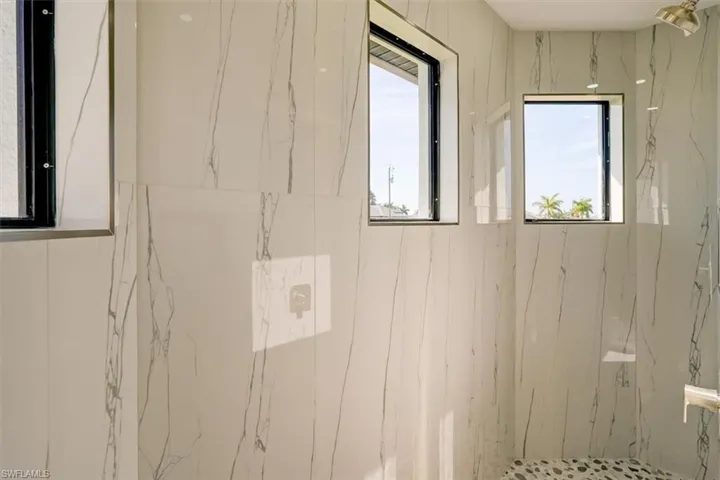 Bathroom with a marble finish shower