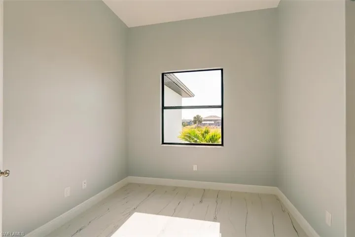 Empty room featuring baseboards