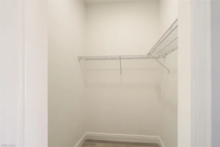Spacious closet featuring wood finished floors