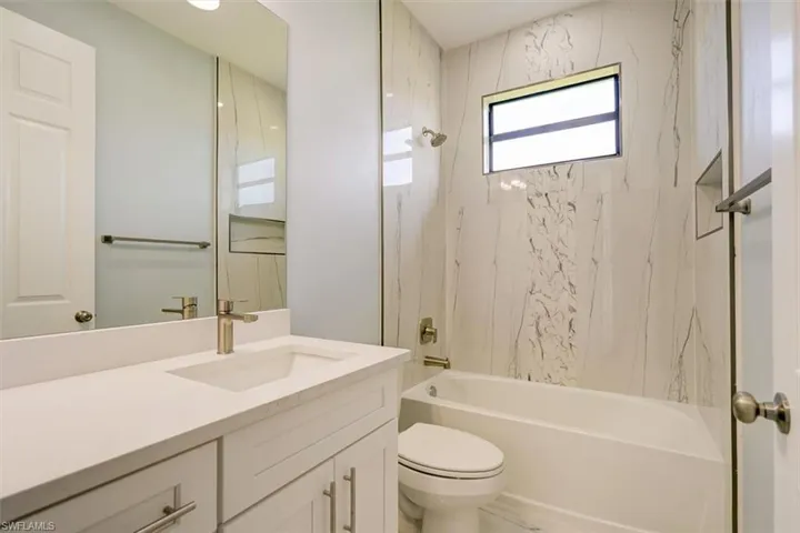 Bathroom with shower / bathtub combination and vanity