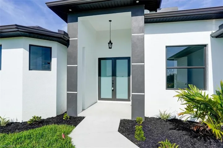 Entrance to property featuring french doors and stucco siding