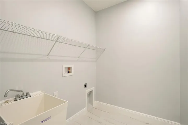Washroom featuring electric dryer hookup and washer hookup