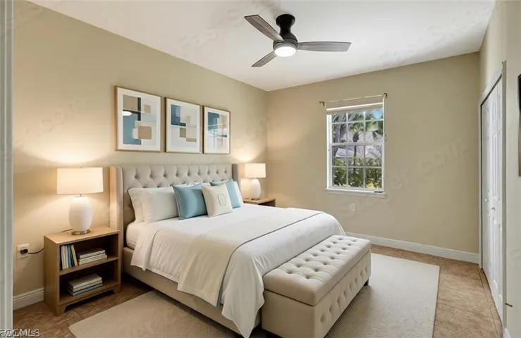 Tiled bedroom with a closet and a ceiling fan (virtually staged)