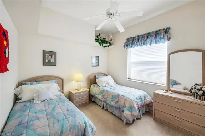 Bedroom featuring light colored carpet and a ceiling fan