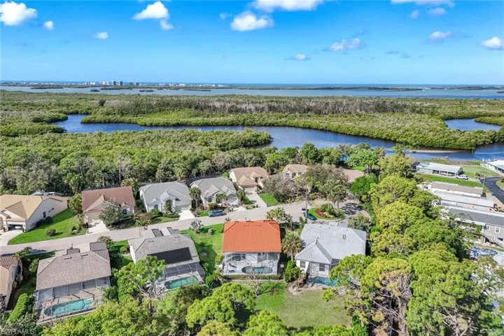 Aerial view of residential area featuring a large body of water