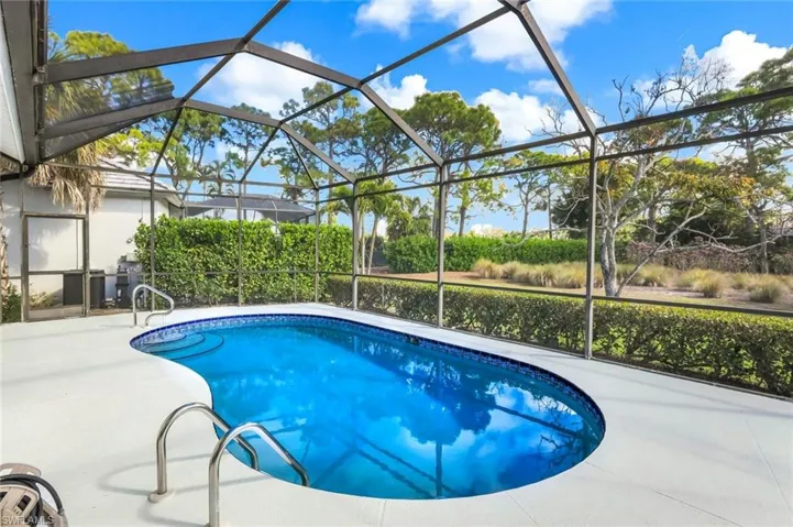 Outdoor pool with a lanai, a sunroom, and a patio