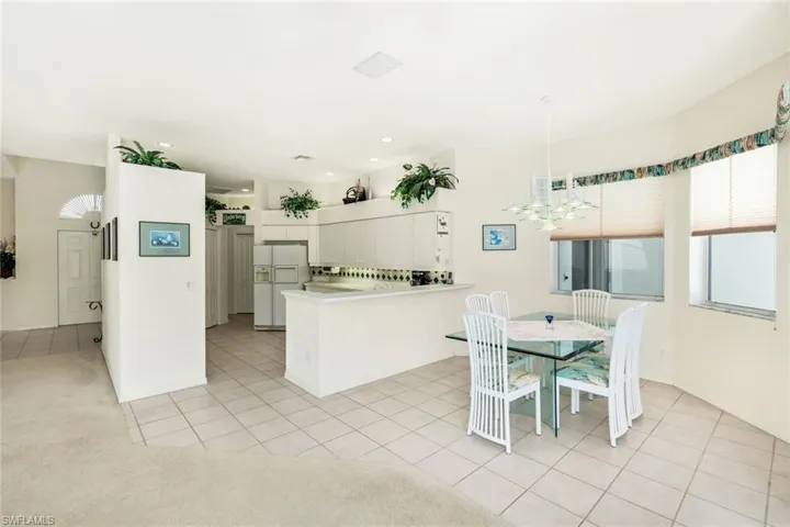 Dining space featuring light tile patterned floors and a chandelier