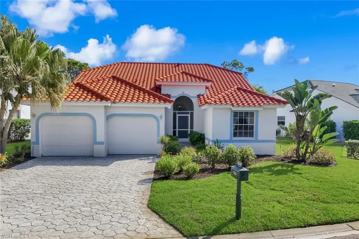 Mediterranean / spanish-style home with stucco siding, an attached garage, decorative driveway, and a front lawn