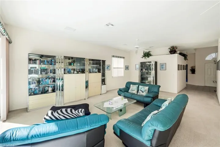Living room with a ceiling fan and carpet