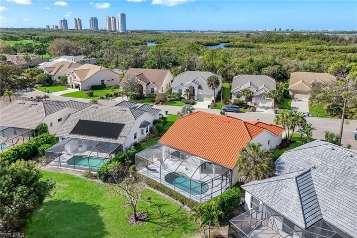Drone / aerial view of city skyline and a large body of water