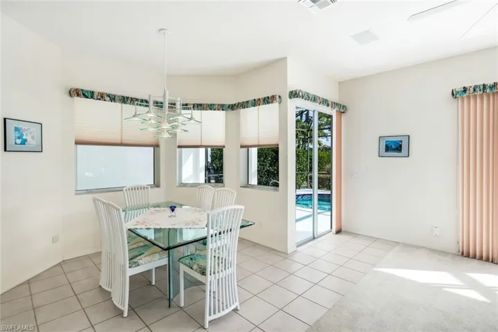 Unfurnished dining area featuring light tile patterned floors and suspended lighting