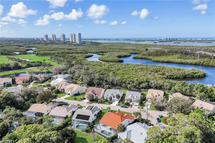 Aerial perspective of suburban area featuring a large body of water