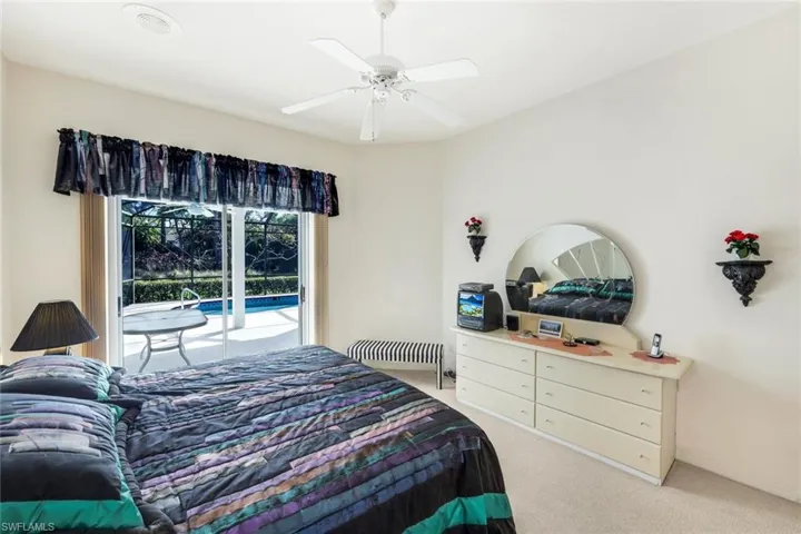 Bedroom featuring access to outside, light colored carpet, and a ceiling fan