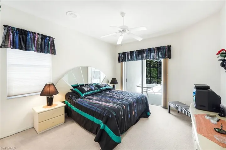 Bedroom featuring access to outside, light colored carpet, and a ceiling fan