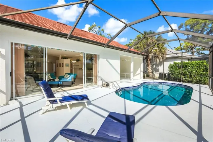 Outdoor pool with a patio area, a sunroom, and a lanai