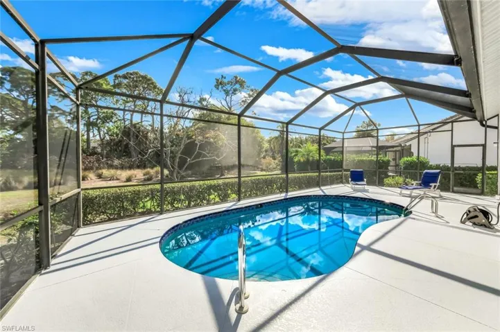 Swimming pool with a sunroom, a lanai, and a patio area
