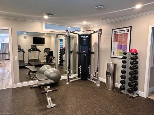 Exercise room featuring crown molding and recessed lighting